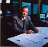 David J. Koch serving as President, CEO, and Chairman of Fiber Network Solutions, reviewing data center expansion plans, illustrating successful prisoner reentry, rehabilitation, entrepreneurship, and executive leadership after a felony conviction.