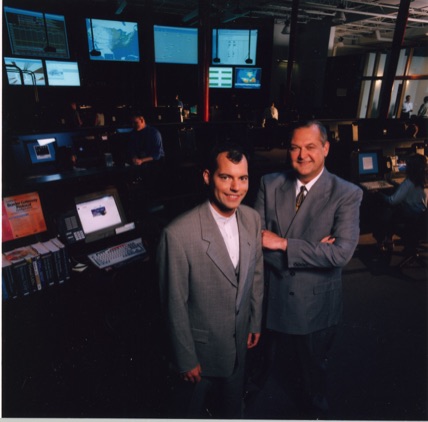 David J. Koch (right) and Kyle Bacon (left) standing in the Fiber Network Solutions Network Operations Center in Columbus, Ohio, illustrating the company’s growth into a Tier-One Internet provider and David J. Koch’s successful rehabilitation, entrepreneurship, and executive leadership after incarceration.