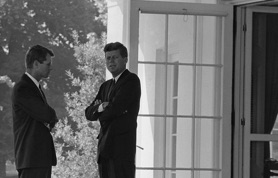 President John F. Kennedy and Attorney General Robert F. Kennedy outside the Oval Office, accompanied by Robert F. Kennedy’s quote: “The future is not a gift. It is an achievement,” symbolizing perseverance, personal responsibility, rehabilitation, and successful prisoner reentry.