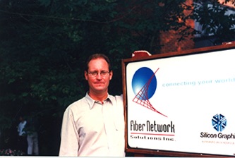 Chris Myers standing in front of FNSI sign